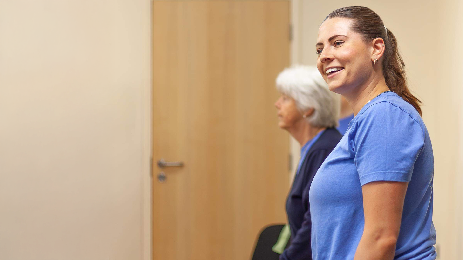 Two members waiting in the studio before an Enable Fitness class.